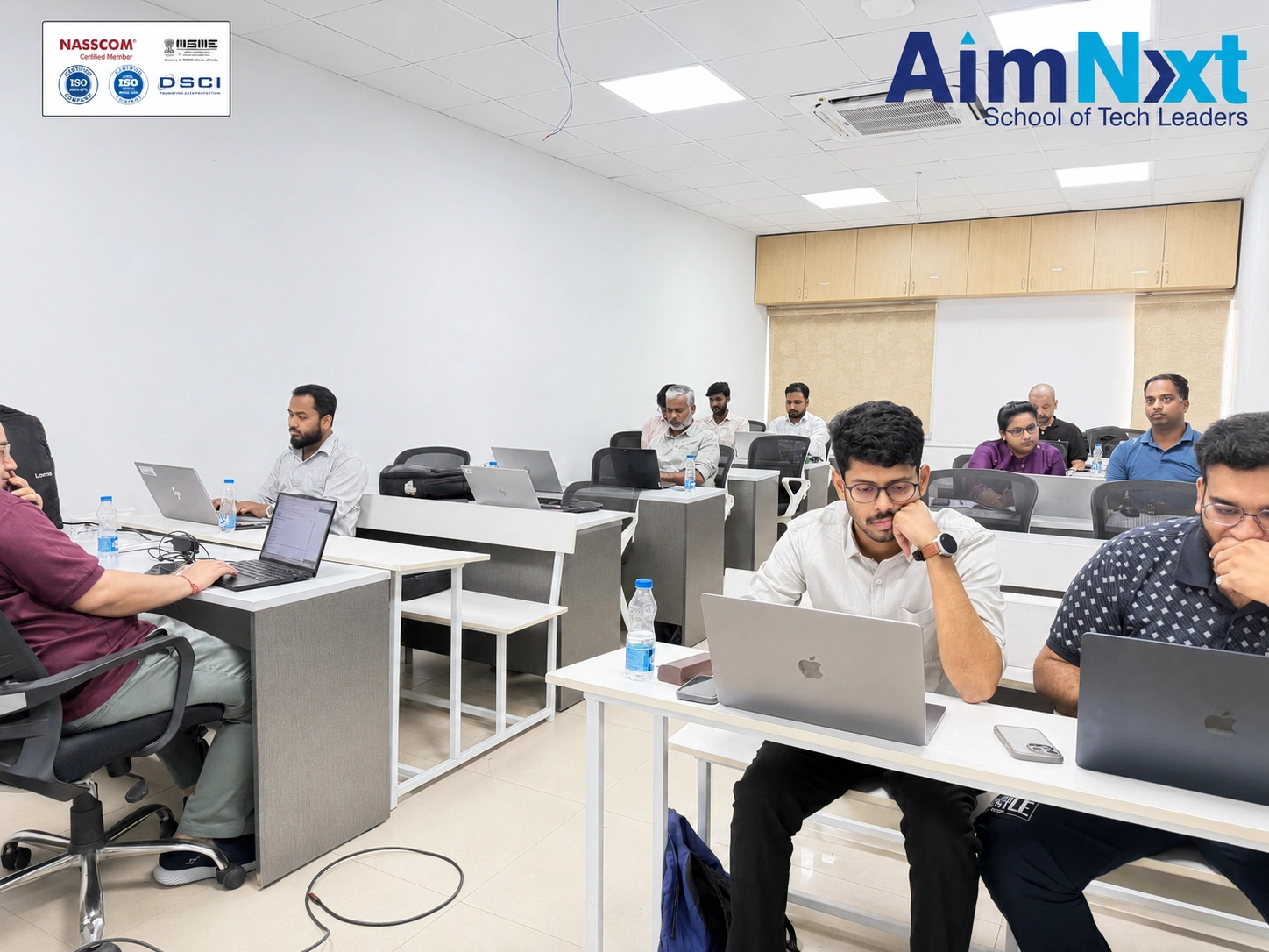 Professionals attending AimNxt Corporate Training program in Hyderabad with hands-on technical learning in a modern classroom